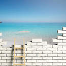 Фотообои с видом на море через кирпичную стену